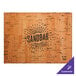 A rectangular natural cork placemat with a logo.