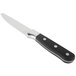 A Libbey stainless steel steak knife with a black handle.