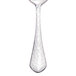A Walco stainless steel demitasse spoon with a textured handle.