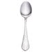 A Walco stainless steel demitasse spoon with an ironstone white handle.