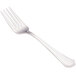 A close-up of a Walco stainless steel salad fork with a white handle.