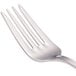 A close-up of four Walco stainless steel salad forks.