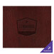 A customizable brown leather rectangle placemat with a logo on a table.