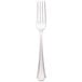 A close-up of a Walco stainless steel dinner fork with a white handle.