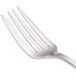 A close-up of a Walco stainless steel flat handle fish fork.