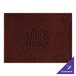 A brown hardboard and faux leather rectangle placemat with customizable words.