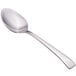 A close-up of a Walco stainless steel demitasse spoon with a silver handle.
