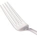 A close-up of a Walco stainless steel table fork with four prongs.