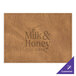 A brown faux leather rectangle placemat with customizable text on a table.