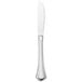 A silver Walco stainless steel dinner knife with a white background.