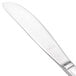 A close-up of a silver Walco Prim butter knife with a white surface.