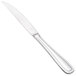 A Walco stainless steel steak knife with a solid handle.