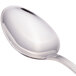 A close-up of a Walco stainless steel teaspoon with a silver handle.