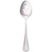 A Walco stainless steel pierced serving spoon with a flower design on it.