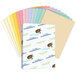 A box of Hammermill tan recycled colored copy paper with a stack of colored papers.