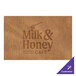 A brown rectangular faux leather placemat with the Milk & Honey Cafe logo.