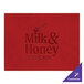 A red faux leather rectangle placemat with text on it.