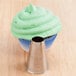 A cupcake with green frosting piped using an Ateco plain nozzle.