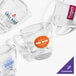 A case of clear glass Acopa espresso cups with custom logos.