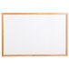 An Aarco oak menu board with a white background and wooden frame.