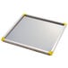 A white metal tray with yellow corners.