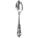 A close-up of a Walco Classic Baroque stainless steel demitasse spoon with a pattern on the handle.