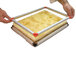 A person using a Matfer Bourgeat square metal frame.