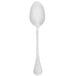 A Walco Soho stainless steel serving spoon with a white handle.