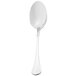 A Walco Soho stainless steel dessert spoon with a white handle.