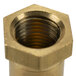 A close up of a brass hexagonal nut with threading.