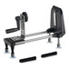 A black and silver Bron Coucke Le Rouet manual spiral vegetable slicer on a table with two brushes.