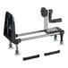 A black and silver Bron Coucke Le Rouet manual spiral vegetable slicer on a table with metal legs.