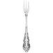 A silver Walco Classic Baroque cocktail fork with a floral design.