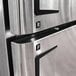 A close up of the stainless steel Turbo Air M3 Series refrigerator and freezer with the letters R and F.