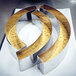 A close-up of a Matfer Bourgeat stainless steel round cake ring on a cake.