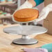 A 12-inch revolving cake stand made of metal, designed for decorating cakes.
