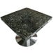 An Art Marble Uba Tuba granite table top with drop leaf extensions.