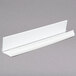 A white rectangular plastic ID tag for Cambro Camshelving on a gray surface.