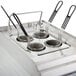 A Waring electric pasta cooker with three baskets on a counter in a school kitchen.