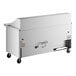 A white True 3 door mega top refrigerated sandwich prep table with a black handle on wheels.
