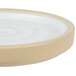 A close up of a Chef & Sommelier white ceramic stoneware plate with a circular rim.