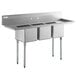 A Regency stainless steel three compartment sink with two drainboards.