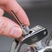 A hand holding the iSi Stainless Steel Injector Tip.