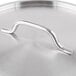 A close-up of a silver stainless steel lid handle.