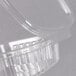 A close-up of a clear Genpak hinged deli container with a lid.