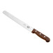 A Victorinox slicing and carving knife with a wooden handle.