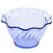 A transparent blue glass tulip dessert dish with a wavy edge.