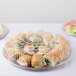 A Durable Packaging plastic dome lid on a plastic container with a sandwich inside.