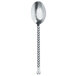 A close up of a Walco stainless steel teaspoon with a long handle.