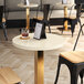 A white Art Marble Furniture round quartz table top on a table.